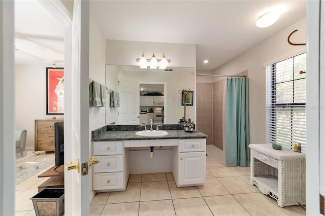 bathroom featuring a shower with curtain, vanity, and tile patterned floors