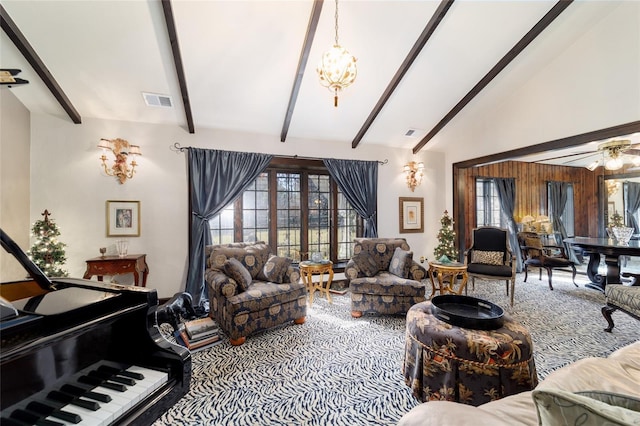 living room with high vaulted ceiling, beam ceiling, visible vents, and ceiling fan with notable chandelier