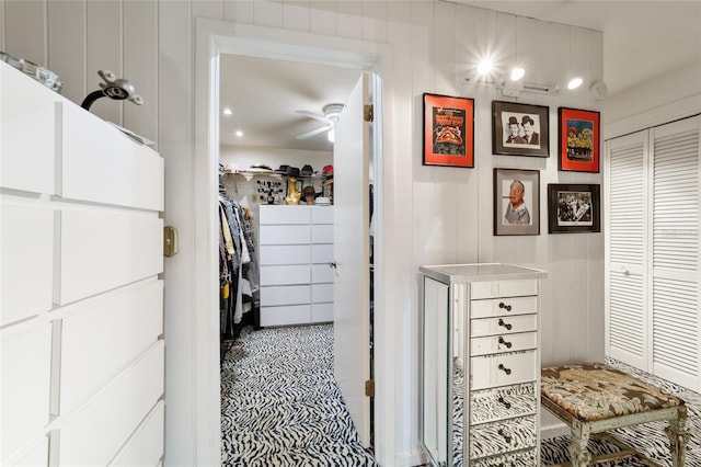 walk in closet featuring ceiling fan