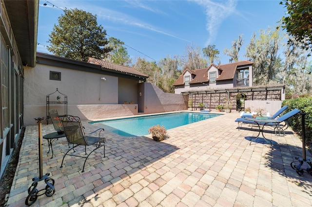 view of swimming pool featuring a fenced in pool, a patio, and fence