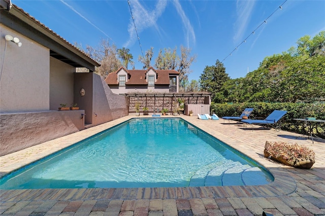 view of swimming pool with a patio area and a fenced in pool