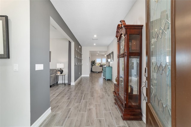 hallway with wood finish floors and baseboards