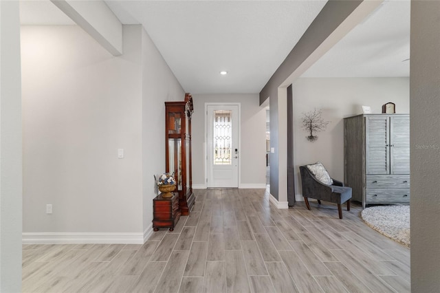 entryway with wood tiled floor and baseboards