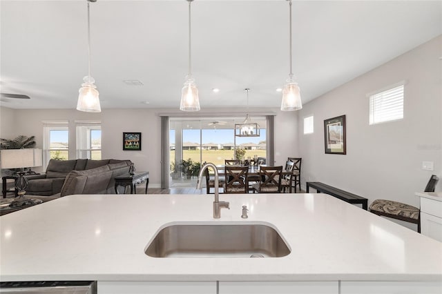 kitchen with dishwasher, plenty of natural light, open floor plan, and a sink