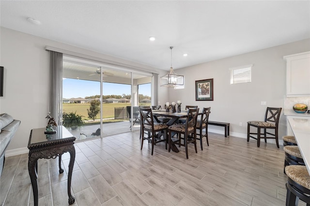 dining area featuring baseboards, recessed lighting, plenty of natural light, and light wood-style floors