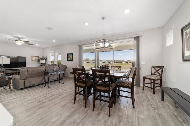 dining space featuring light wood finished floors, plenty of natural light, and visible vents