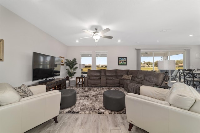 living room with a healthy amount of sunlight, wood finished floors, and recessed lighting