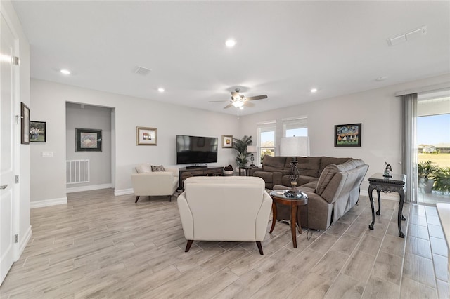 living area featuring light wood-type flooring, visible vents, a wealth of natural light, and recessed lighting