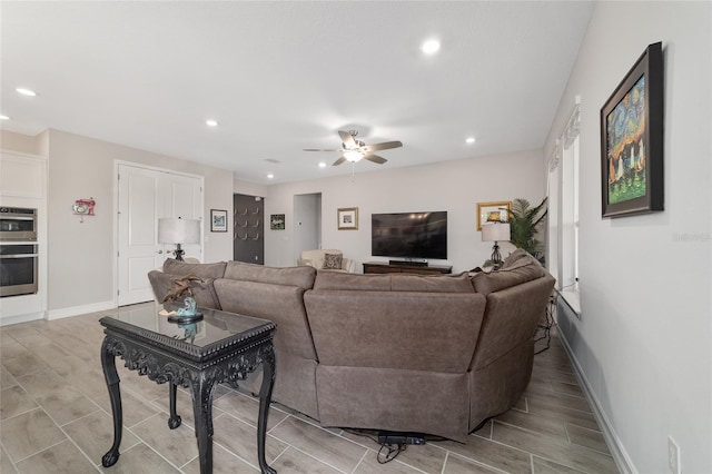 living area featuring recessed lighting, ceiling fan, and baseboards