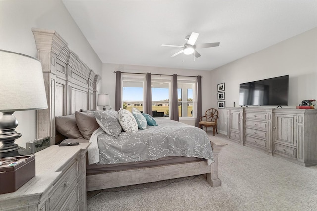 bedroom featuring light carpet, baseboards, and a ceiling fan