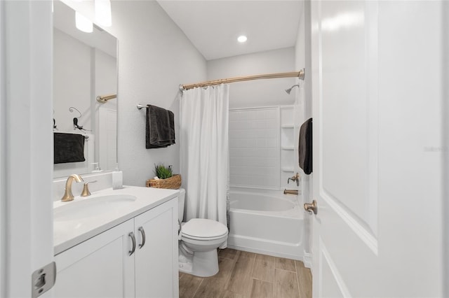 bathroom featuring shower / bath combination with curtain, vanity, toilet, and wood finished floors