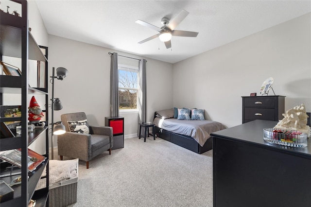 carpeted bedroom featuring a ceiling fan, a textured ceiling, and baseboards