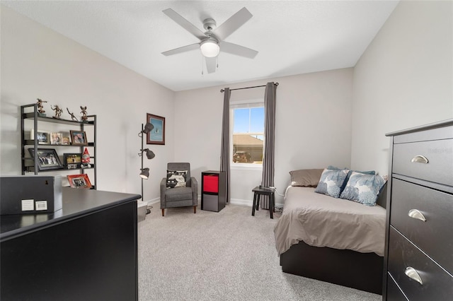 bedroom with baseboards, ceiling fan, and light colored carpet