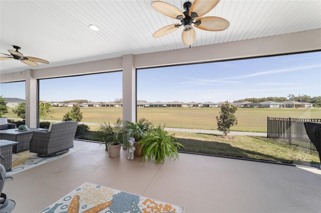 sunroom with a ceiling fan