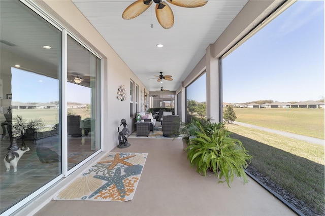 sunroom with visible vents, a wealth of natural light, and a ceiling fan