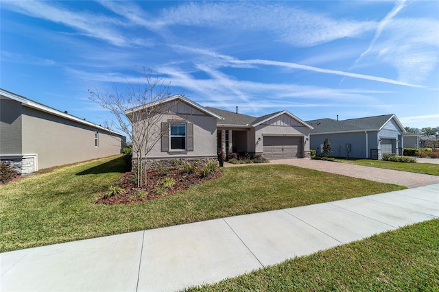 ranch-style house featuring a garage, driveway, and a front lawn