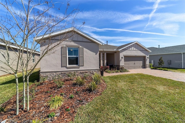 ranch-style house featuring stone siding, an attached garage, decorative driveway, a front yard, and stucco siding