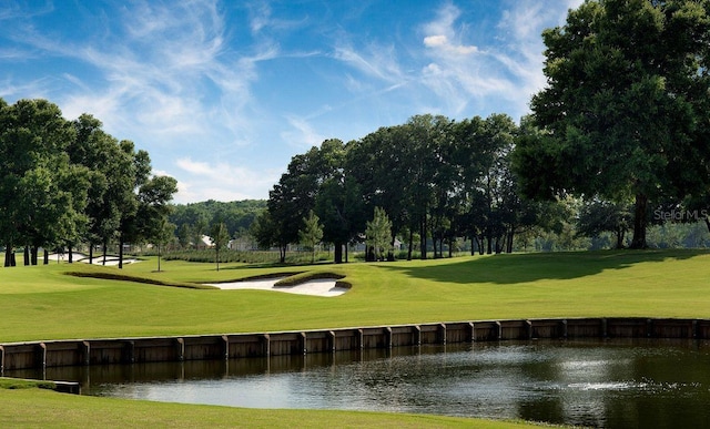 view of property's community featuring a water view, a yard, and golf course view