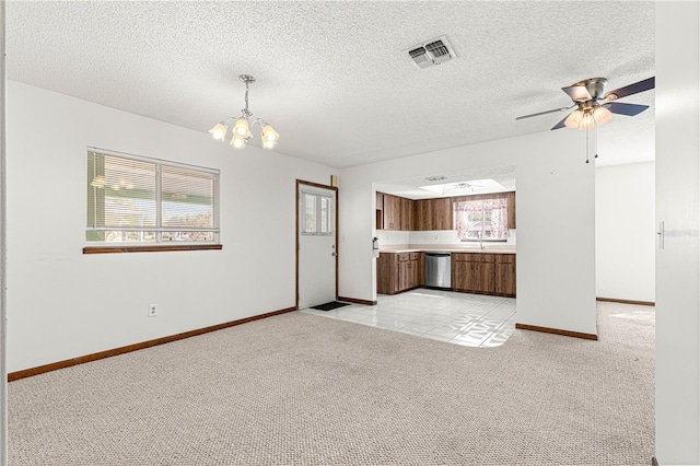 unfurnished living room with light carpet, baseboards, visible vents, a textured ceiling, and ceiling fan with notable chandelier