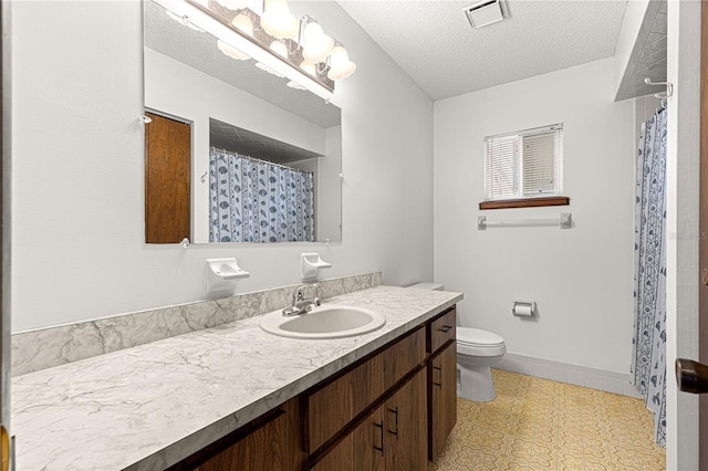 bathroom with visible vents, toilet, a textured ceiling, vanity, and baseboards