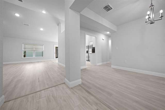 interior space with baseboards, visible vents, and light wood finished floors