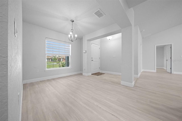 unfurnished dining area with a chandelier, visible vents, light wood-style flooring, and baseboards