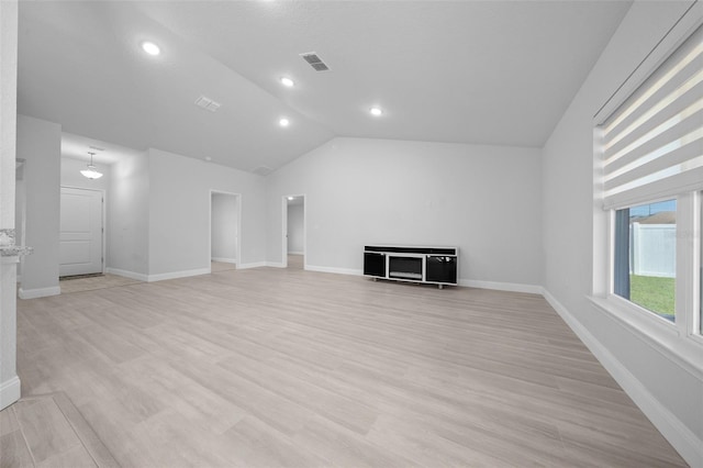 unfurnished living room with lofted ceiling, recessed lighting, visible vents, light wood-style floors, and baseboards