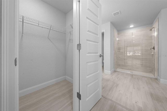 walk in closet featuring light wood finished floors and visible vents