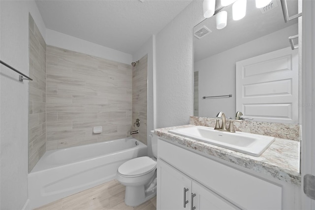 full bathroom with visible vents, shower / tub combination, vanity, and toilet