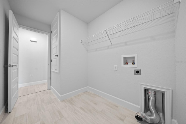 washroom with hookup for a washing machine, light wood-style floors, electric dryer hookup, laundry area, and baseboards