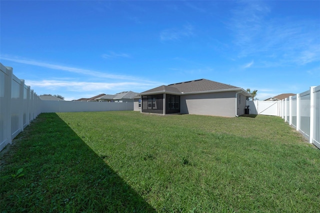 view of yard with a fenced backyard and a sunroom