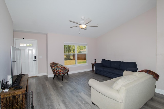 living room with baseboards, ceiling fan, and wood finished floors