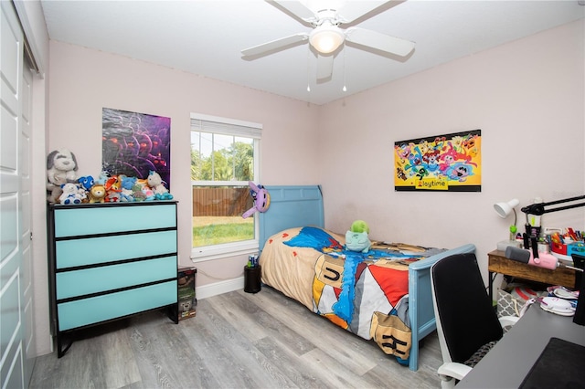 bedroom with a ceiling fan and wood finished floors