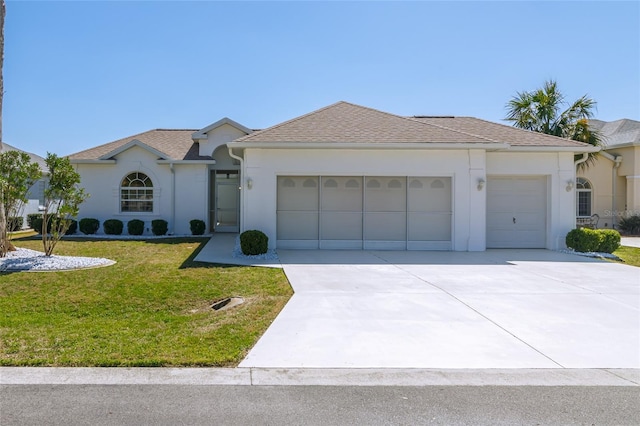 view of front of home featuring a garage, concrete driveway, roof with shingles, a front lawn, and stucco siding