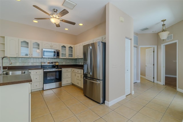 kitchen featuring dark countertops, visible vents, stainless steel appliances, and a sink