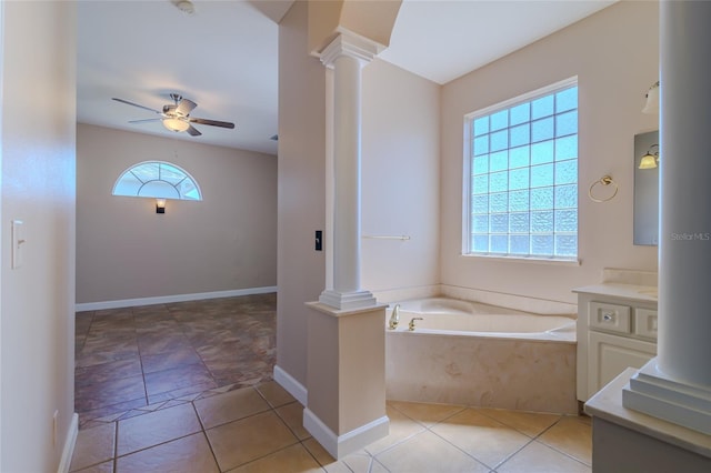 full bath featuring ceiling fan, a garden tub, vanity, tile patterned floors, and ornate columns