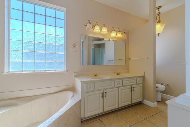 bathroom with toilet, a garden tub, vanity, and tile patterned floors