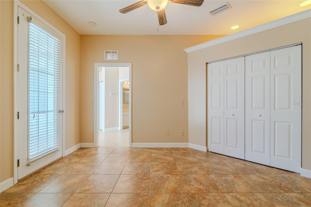 unfurnished bedroom with multiple windows, visible vents, and baseboards