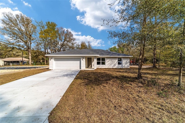 single story home with driveway, a front lawn, an attached garage, and stucco siding