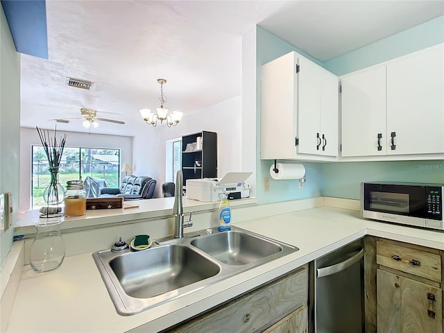 kitchen featuring visible vents, white cabinets, appliances with stainless steel finishes, light countertops, and a sink