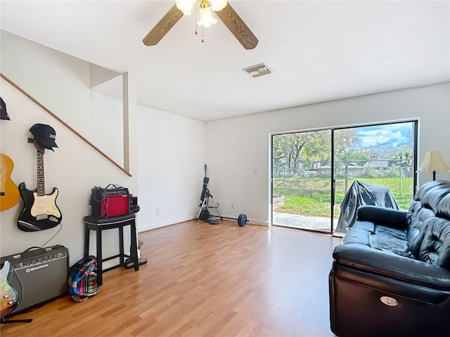 interior space with baseboards, light wood finished floors, visible vents, and a ceiling fan