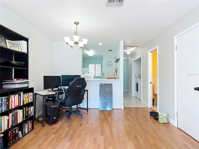 office area with a chandelier, visible vents, baseboards, and wood finished floors