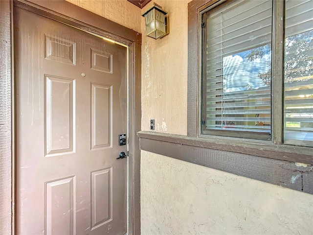 entrance to property featuring stucco siding