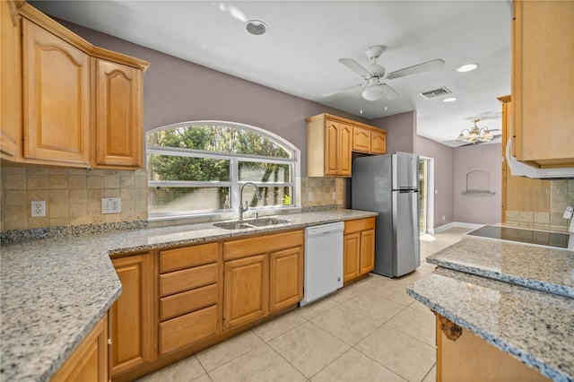 kitchen featuring stove, a sink, visible vents, freestanding refrigerator, and dishwasher