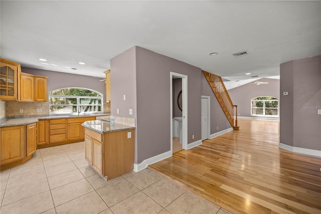 kitchen with ceiling fan, visible vents, tasteful backsplash, and a sink