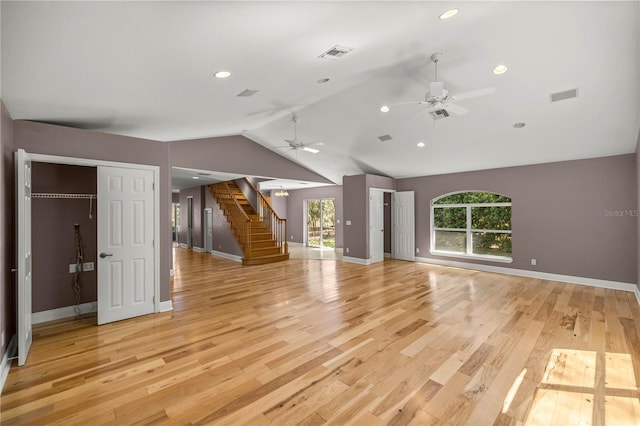 unfurnished living room featuring lofted ceiling, stairway, light wood-style flooring, and visible vents