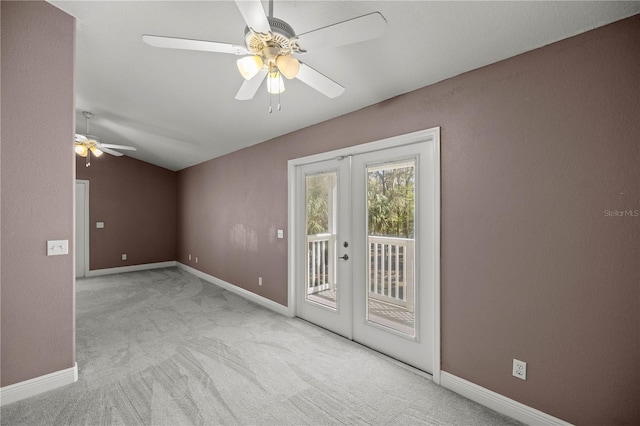 spare room featuring vaulted ceiling, french doors, carpet, and a ceiling fan