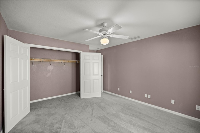 unfurnished bedroom with carpet floors, a closet, visible vents, a ceiling fan, and baseboards