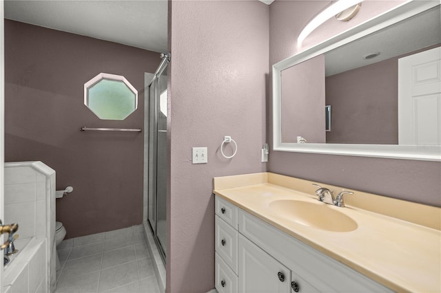 full bath featuring a stall shower, vanity, toilet, and tile patterned floors