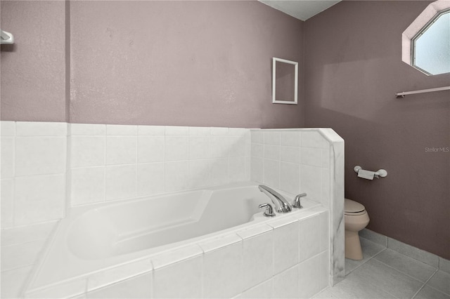 bathroom featuring a bath, toilet, and tile patterned floors